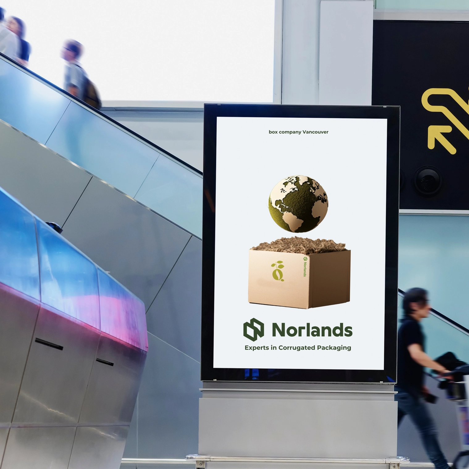 The image highlights an advertisement for Norlands Box Company Vancouver, specializing in sustainable custom boxes and innovative custom printed boxes. The ad features a kraft box filled with soil, with a globe emerging from it, symbolizing eco-friendly packaging solutions. Displayed in a modern public setting, this ad underscores Norlands' expertise in creating high-quality, environmentally responsible packaging tailored to meet diverse business needs.