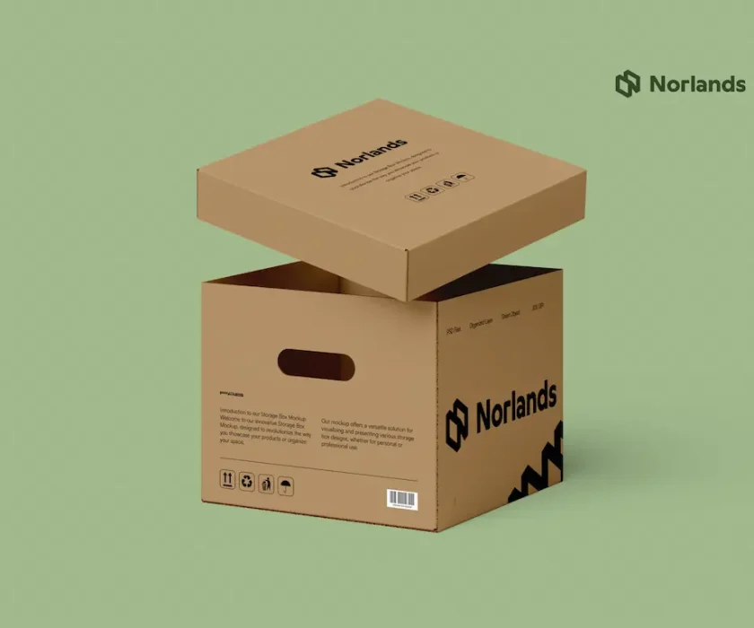 An eco-friendly Norlands cardboard storage box with a removable lid, displayed against a light green background. The box features cutout handles, printed icons, and the Norlands logo in bold black.