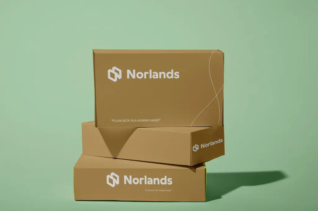 Two stacked Norlands branded cardboard packaging boxes displayed against a green background, highlighting clean and professional design.