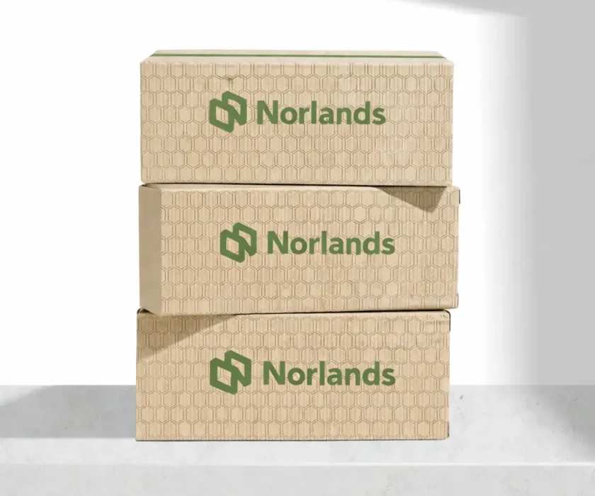 Stacked kraft corrugated boxes showcasing sustainable packaging material decisions BC for strength, recyclability, and performance consistency