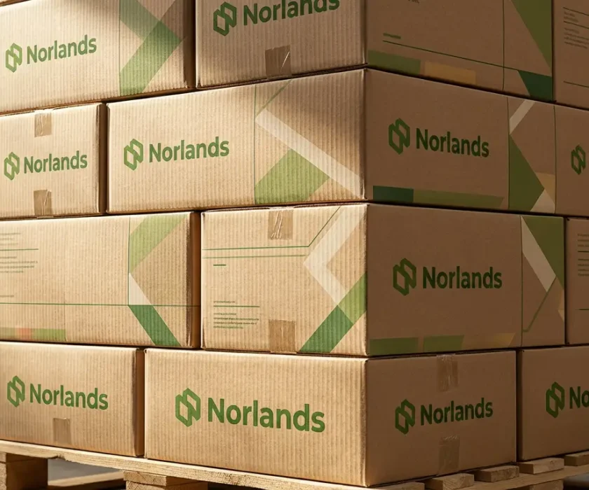 Stacked branded corrugated boxes on pallets representing regional packaging manufacturing Canada storage, inventory management, and shipping readiness